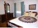 Bedroom featuring a four-poster bed, dresser, mirror, and bright natural light at 9 Silver Sand Rd, Frostproof, FL 33843