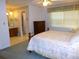 Bedroom featuring a cozy bed, dresser, and an en-suite bathroom at 9 Silver Sand Rd, Frostproof, FL 33843