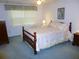 Bedroom with a comfortable bed, natural light, and classic decor elements at 9 Silver Sand Rd, Frostproof, FL 33843