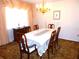 Formal dining room with chandelier and large window at 9 Silver Sand Rd, Frostproof, FL 33843