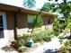 Exterior view of a well-maintained brick home with a manicured garden and walkway at 9 Silver Sand Rd, Frostproof, FL 33843