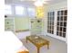 Bright living room with wicker furniture and shelving at 9 Silver Sand Rd, Frostproof, FL 33843