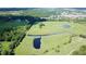 Expansive aerial view showcasing the community with ponds and greenery at 1077 Medinah Way, Winter Haven, FL 33884