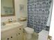 Cozy bathroom with floral shower curtain, updated sink and a built in medicine cabinet at 1077 Medinah Way, Winter Haven, FL 33884
