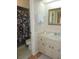 Well-lit bathroom with a shower/tub combo and vanity with storage at 1077 Medinah Way, Winter Haven, FL 33884