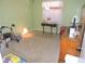 Green bedroom with neutral carpet, window, side table, and dresser at 1077 Medinah Way, Winter Haven, FL 33884
