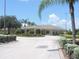 Exterior view of community clubhouse featuring manicured landscaping and a circular driveway at 1077 Medinah Way, Winter Haven, FL 33884