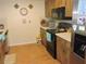 Efficient kitchen showcasing wood cabinetry, tile floors, and a full range of appliances at 1077 Medinah Way, Winter Haven, FL 33884