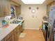 Functional kitchen with tile flooring, ample counter space, and wood cabinetry at 1077 Medinah Way, Winter Haven, FL 33884