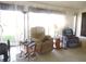 Cozy living room showcasing carpet flooring and large windows at 1077 Medinah Way, Winter Haven, FL 33884