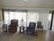 Bright living room featuring tile flooring and large windows for natural light at 1077 Medinah Way, Winter Haven, FL 33884