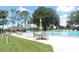 Community pool with lounge chairs and table seating for residents at 1077 Medinah Way, Winter Haven, FL 33884