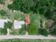 Aerial view of a well-maintained home, surrounded by mature trees and a freshly mowed lawn, showcasing curb appeal at 111 D St, Frostproof, FL 33843