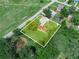 Aerial view of the property with its mature trees and proximity to nearby roads at 111 D St, Frostproof, FL 33843