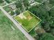 Aerial view of the home, set within a large lot featuring mature landscaping at 111 D St, Frostproof, FL 33843