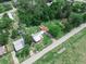Overhead aerial view of a property with lush greenery, showcasing two structures and a well-maintained lawn at 111 D St, Frostproof, FL 33843