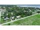 A serene neighborhood captured from above, blending nature with charming homes against a backdrop of a tranquil lake at 111 D St, Frostproof, FL 33843