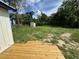 Backyard with deck, grass and greenery, shed and ample space at 111 D St, Frostproof, FL 33843
