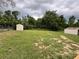 Expansive backyard featuring a shed and green grass, perfect for outdoor activities at 111 D St, Frostproof, FL 33843