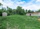 The property's generous backyard has grass, sandy spots, a shed, and mature trees at 111 D St, Frostproof, FL 33843