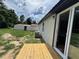 Backyard with a new wooden deck and sliding glass doors that lead into the home at 111 D St, Frostproof, FL 33843