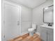Stylish bathroom boasts a modern vanity, toilet, and shower, complemented by luxury vinyl plank flooring at 111 D St, Frostproof, FL 33843
