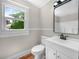 Cozy bathroom with a new vanity, updated fixtures, and a modern mirror at 111 D St, Frostproof, FL 33843