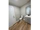 Bathroom featuring modern vanity, toilet, door, and stylish gray color scheme at 111 D St, Frostproof, FL 33843