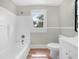 Charming bathroom featuring a tub, shower, toilet and sink with classic finishes at 111 D St, Frostproof, FL 33843