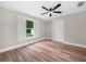 Cozy bedroom with ceiling fan and luxury vinyl plank flooring. Natural light from the window at 111 D St, Frostproof, FL 33843