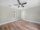 Airy bedroom featuring ceiling fan, natural light from the window, and luxury vinyl plank flooring at 111 D St, Frostproof, FL 33843