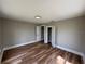 Spacious bedroom features wood floor, fresh paint, new lighting, and closet at 111 D St, Frostproof, FL 33843