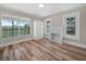 Bright bedroom with a decorative fireplace, closet, and luxury vinyl plank flooring at 111 D St, Frostproof, FL 33843