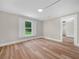Well-lit bedroom with luxury vinyl plank flooring, offering a warm and inviting atmosphere at 111 D St, Frostproof, FL 33843