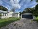 Charming home exterior with a detached garage and a well-maintained lawn at 111 D St, Frostproof, FL 33843