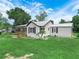 Charming home with a metal roof, a cozy porch, and a well-maintained lawn at 111 D St, Frostproof, FL 33843