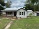 Charming home exterior with a front porch, complemented by a well-maintained lawn at 111 D St, Frostproof, FL 33843