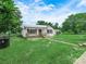 Home showcases a welcoming front porch, classic curb appeal, and garage in back at 111 D St, Frostproof, FL 33843