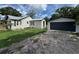 Charming home exterior with a separate garage and well-maintained lawn at 111 D St, Frostproof, FL 33843