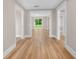 Open hallway with wood-look floors and neutral paint, leading to a bright outdoor view at 111 D St, Frostproof, FL 33843