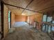 Spacious interior with plywood walls and exposed beams, offering a blank canvas at 111 D St, Frostproof, FL 33843