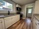 Updated kitchen with granite counters, stainless steel appliances, and modern sink at 111 D St, Frostproof, FL 33843