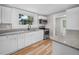 Well-lit kitchen with stainless steel appliances, granite counters, and bright white cabinetry at 111 D St, Frostproof, FL 33843