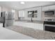 Bright kitchen featuring stainless appliances, granite countertops, and abundant white cabinetry at 111 D St, Frostproof, FL 33843