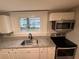 Kitchen featuring granite countertops, stainless steel appliances, and large window at 111 D St, Frostproof, FL 33843