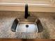 Close-up of granite counters and modern stainless steel kitchen sink at 111 D St, Frostproof, FL 33843