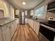Kitchen featuring white cabinets, stainless steel appliances, and granite countertops at 111 D St, Frostproof, FL 33843