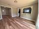 Open-concept living room featuring wood-look floors and pass-through to the kitchen at 111 D St, Frostproof, FL 33843