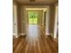 Living room with wood floor and sliding glass door leading to the outside at 111 D St, Frostproof, FL 33843