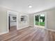 Open living room with a sliding glass door to the backyard and access to the kitchen at 111 D St, Frostproof, FL 33843